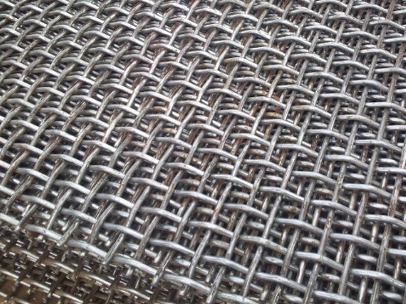 A pile of woven wire mesh are displayed.